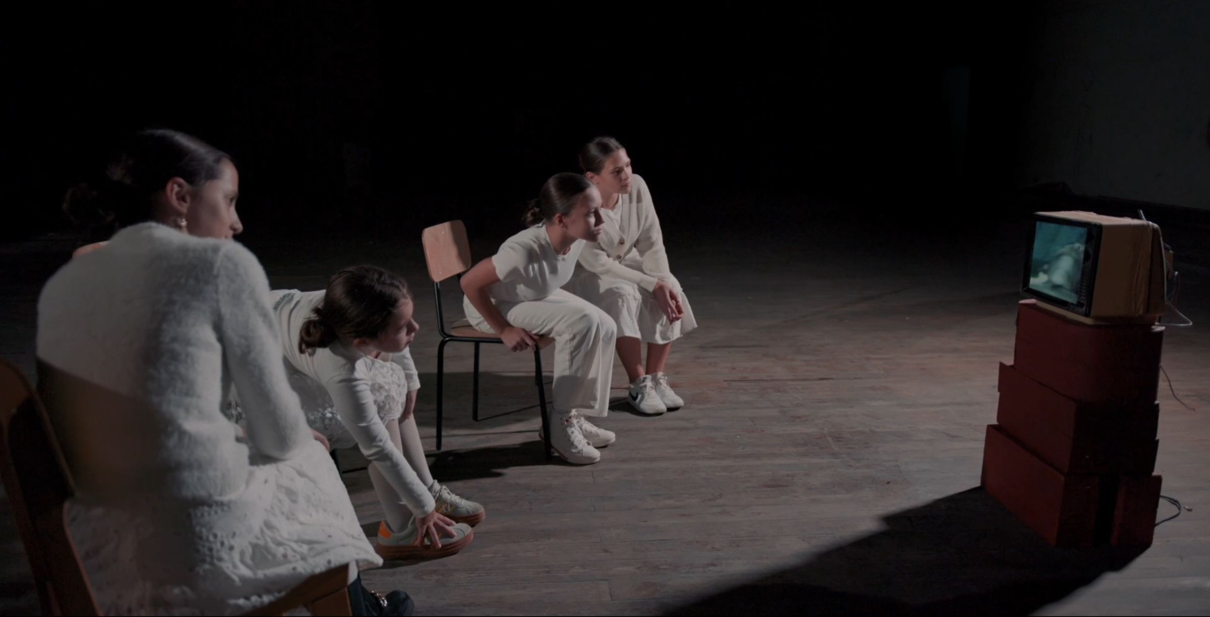 Dancers in white in a dark hall, a still from the Lavah Media teaser